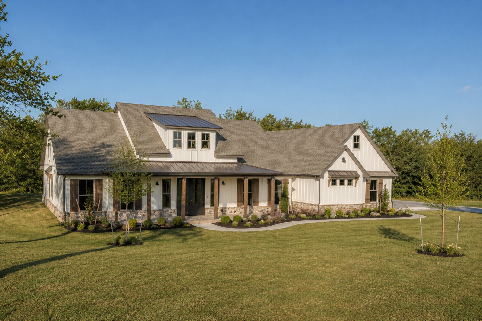 White modern farmhouse custom home with wraparound porch