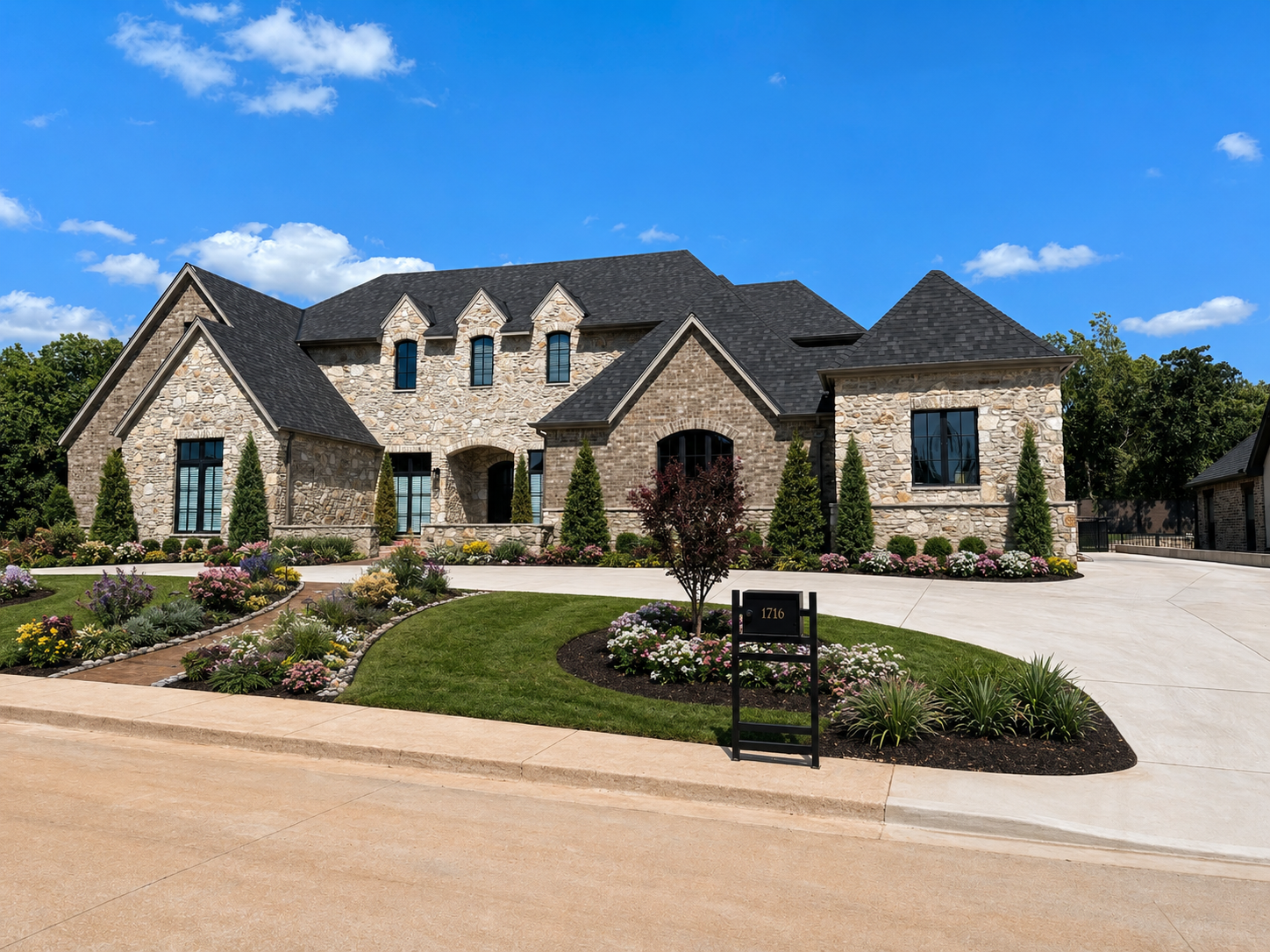 European stone manor custom home with circular drive