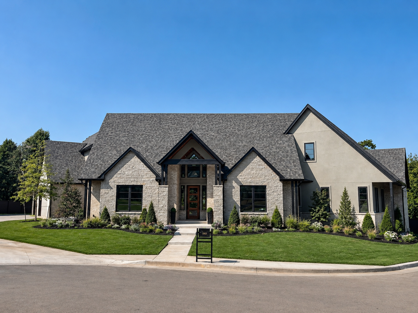 Light stone transitional custom home with multiple gables